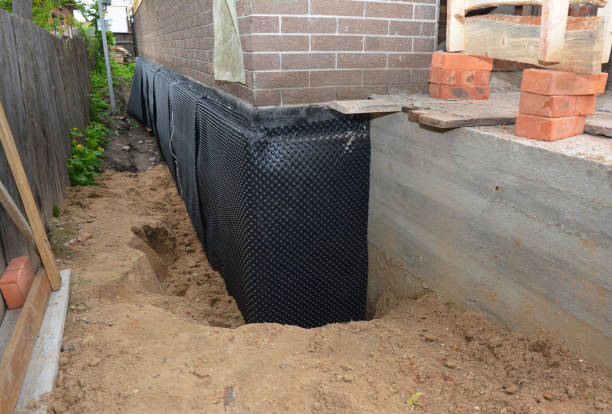 Happy homeowners after waterproofing job in West Olive